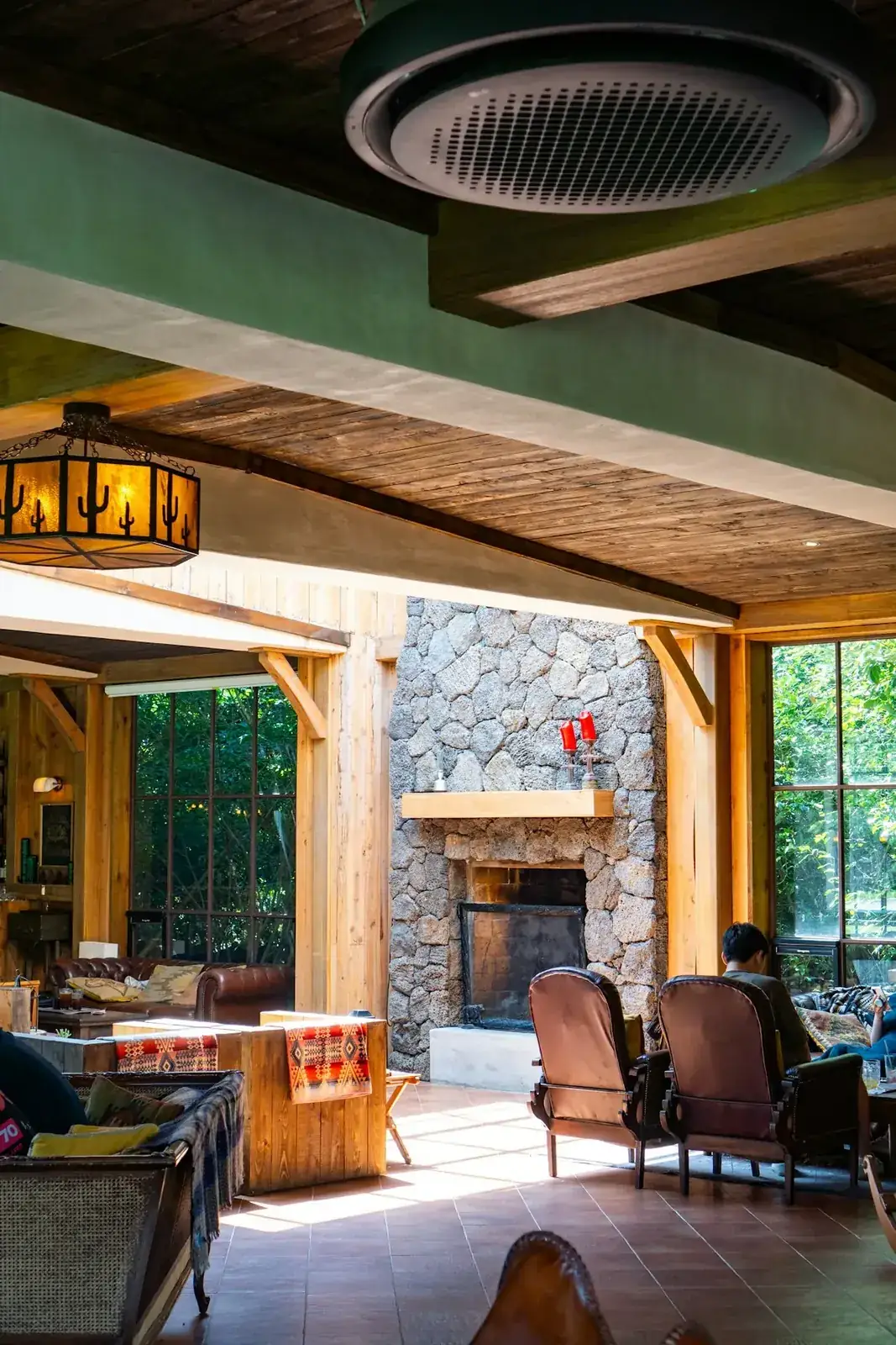 Interior of the mountain cabin showing a cozy fireplace and wooden beams.
